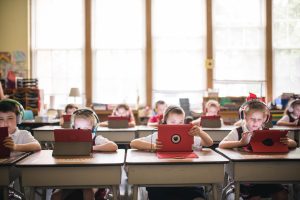 Children at desks using iPads